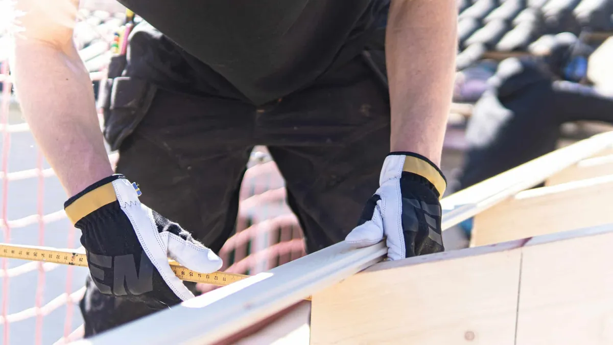 man measuring on construction site