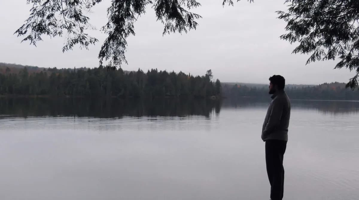 man looking at lake solemnly
