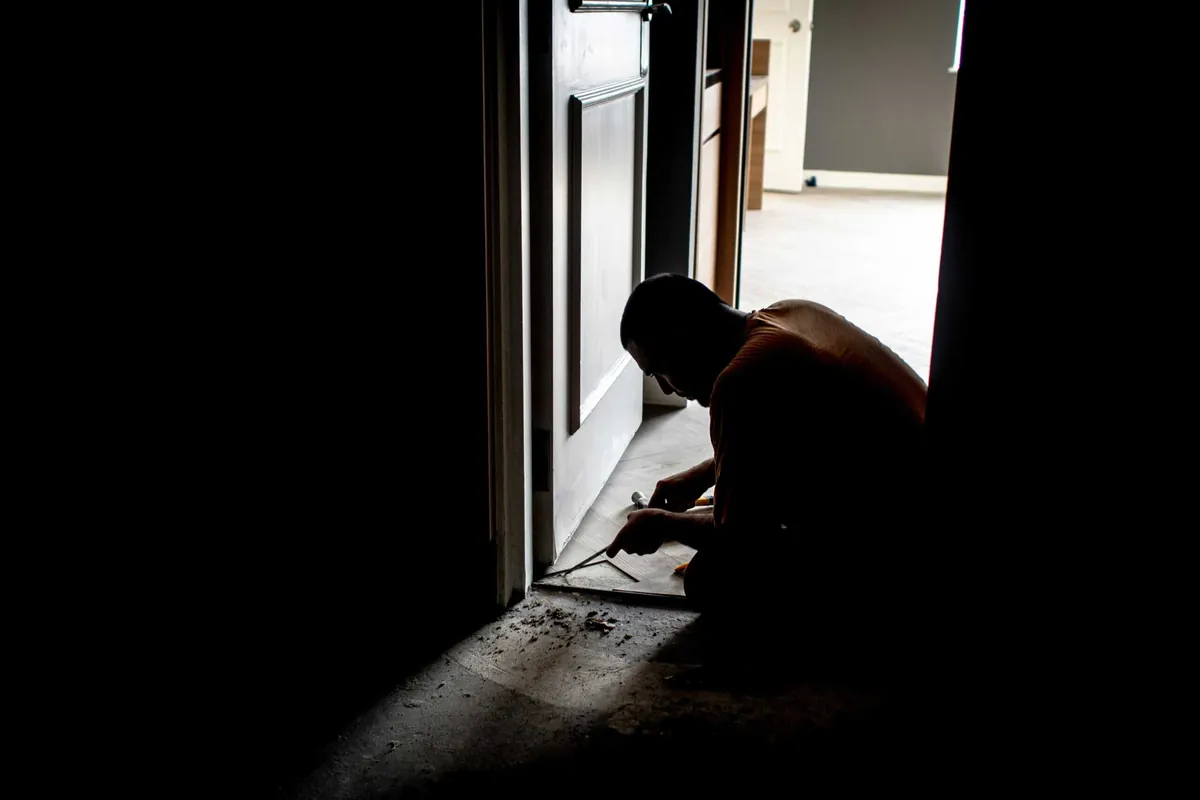 man caulking