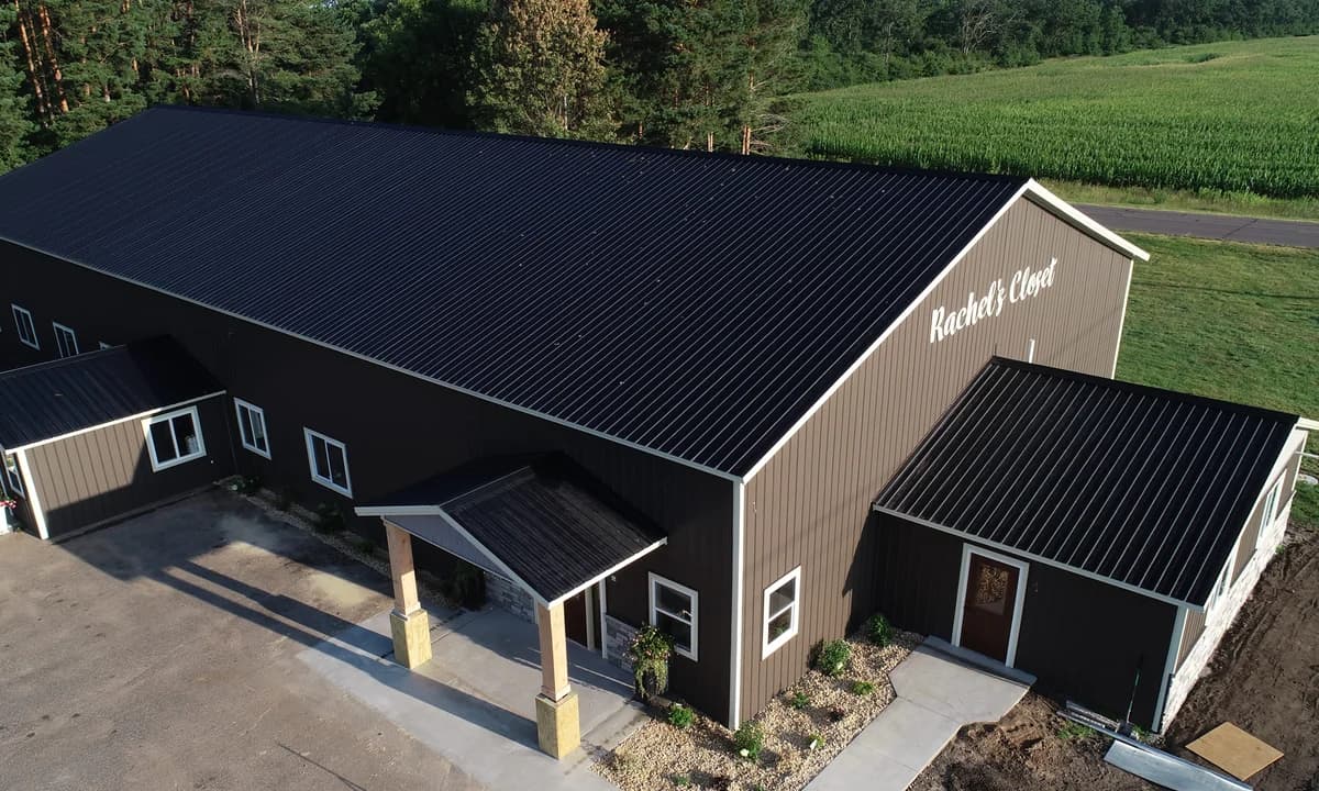 Aerial view of Rachel's Closet commercial building with dark roofing and covered entrances