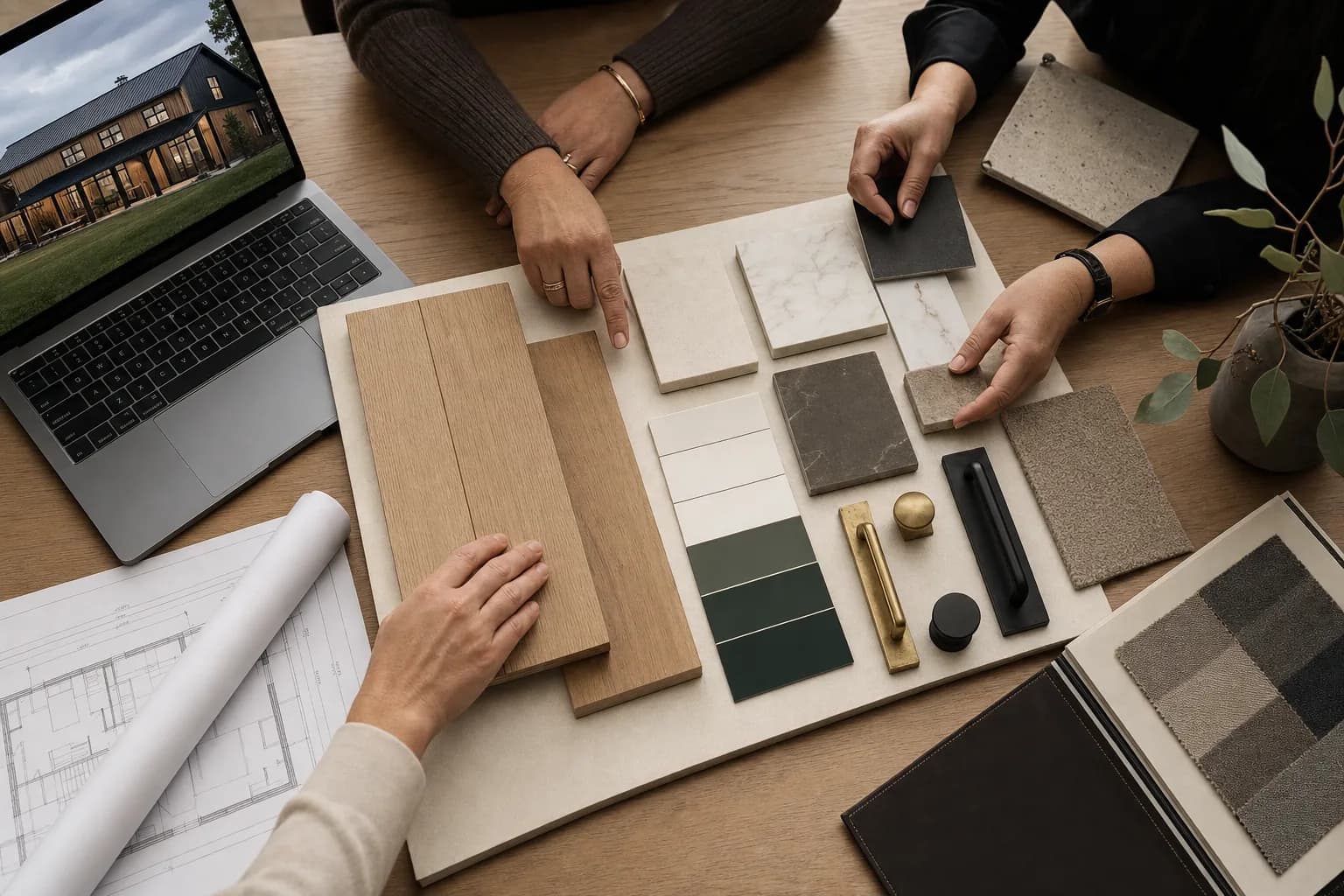 Designer reviewing finish selections — flooring, stone, hardware, and fabric samples — for a Sherman Buildings turnkey custom barndominium