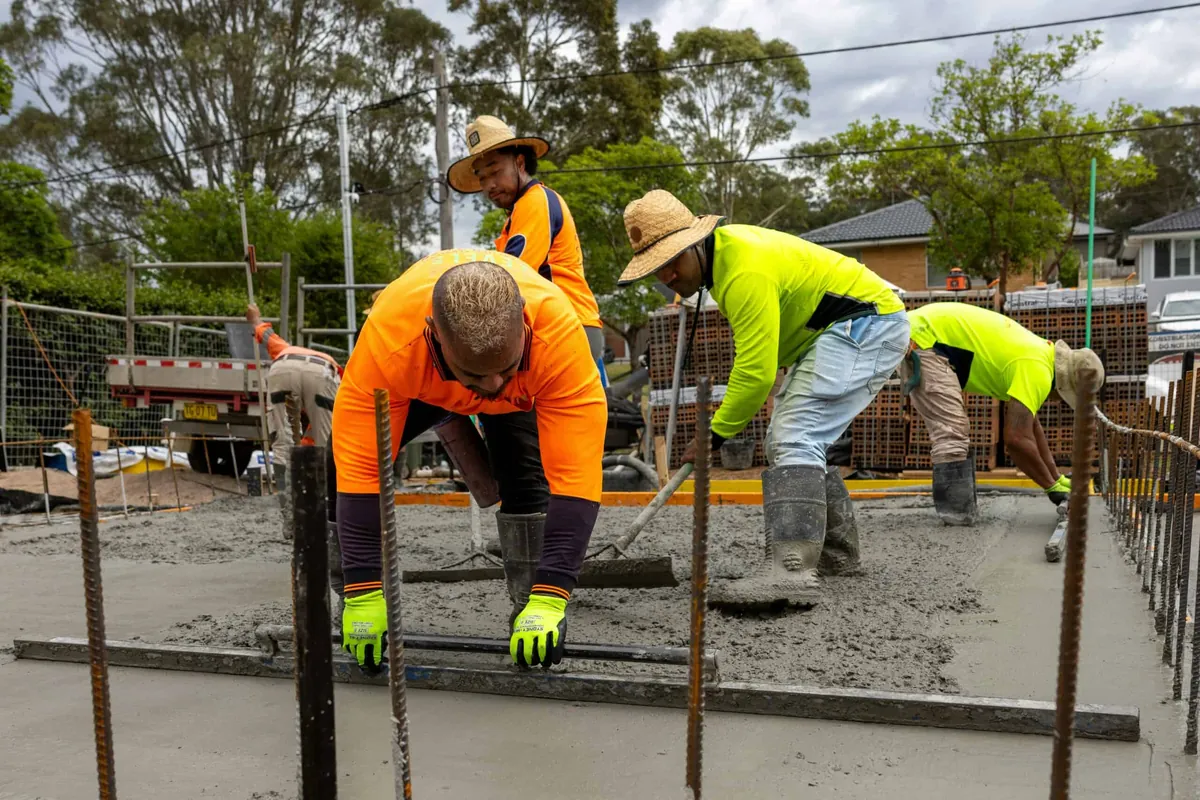 construction workers pouring concrete