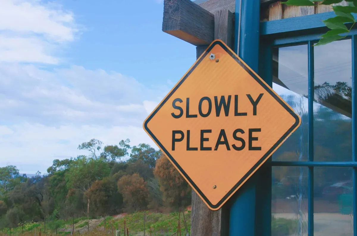 slow please street sign