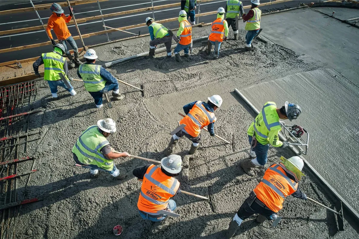 construction workers pouring concrete